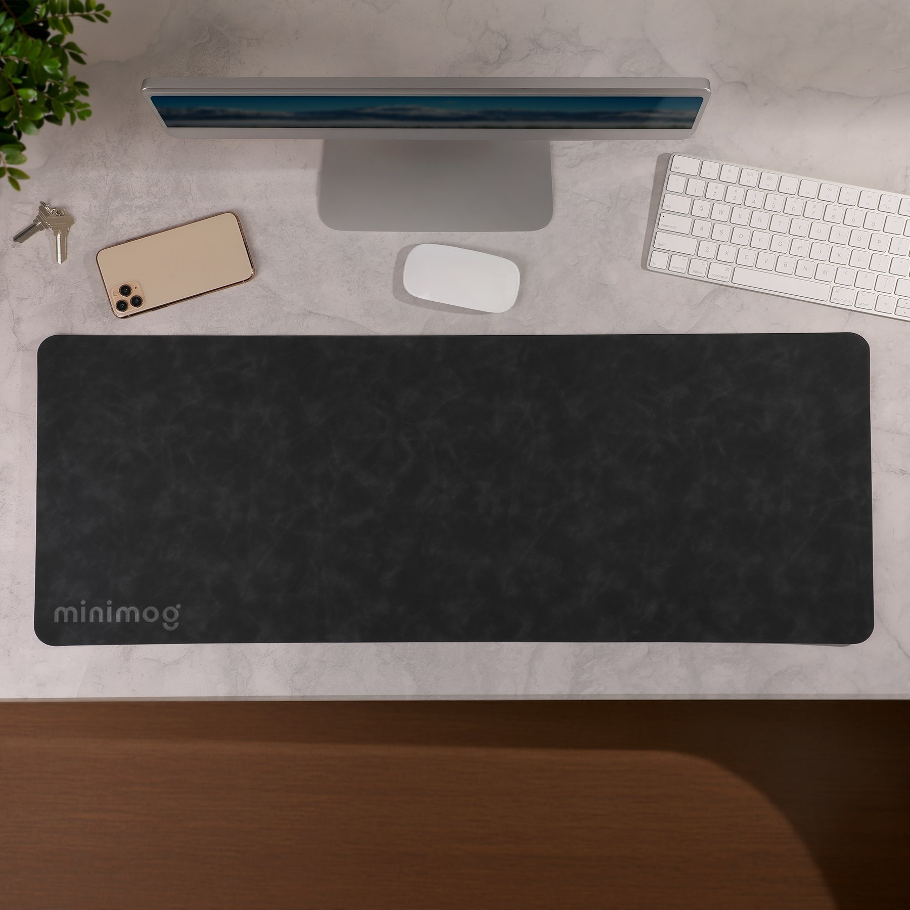 Black Desk Mat Pro Desk Mat in a sleek black PU material with a smooth soft-touch surface, shown as a wide rectangular desk mat designed to cover and protect a desktop workspace.