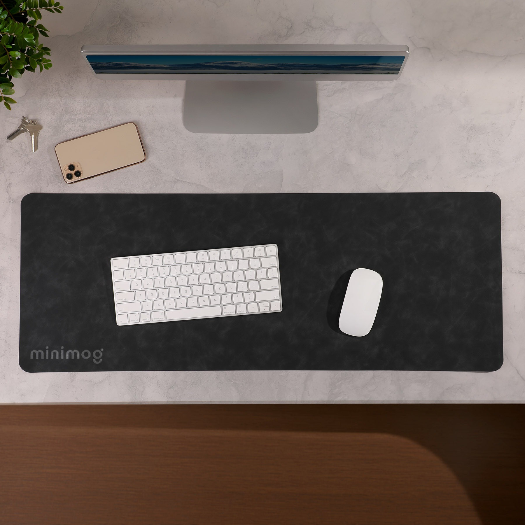 Black Desk Mat Pro Desk Mat in a sleek black PU material with a smooth soft-touch surface, shown as a wide rectangular desk mat designed to cover and protect a desktop workspace.