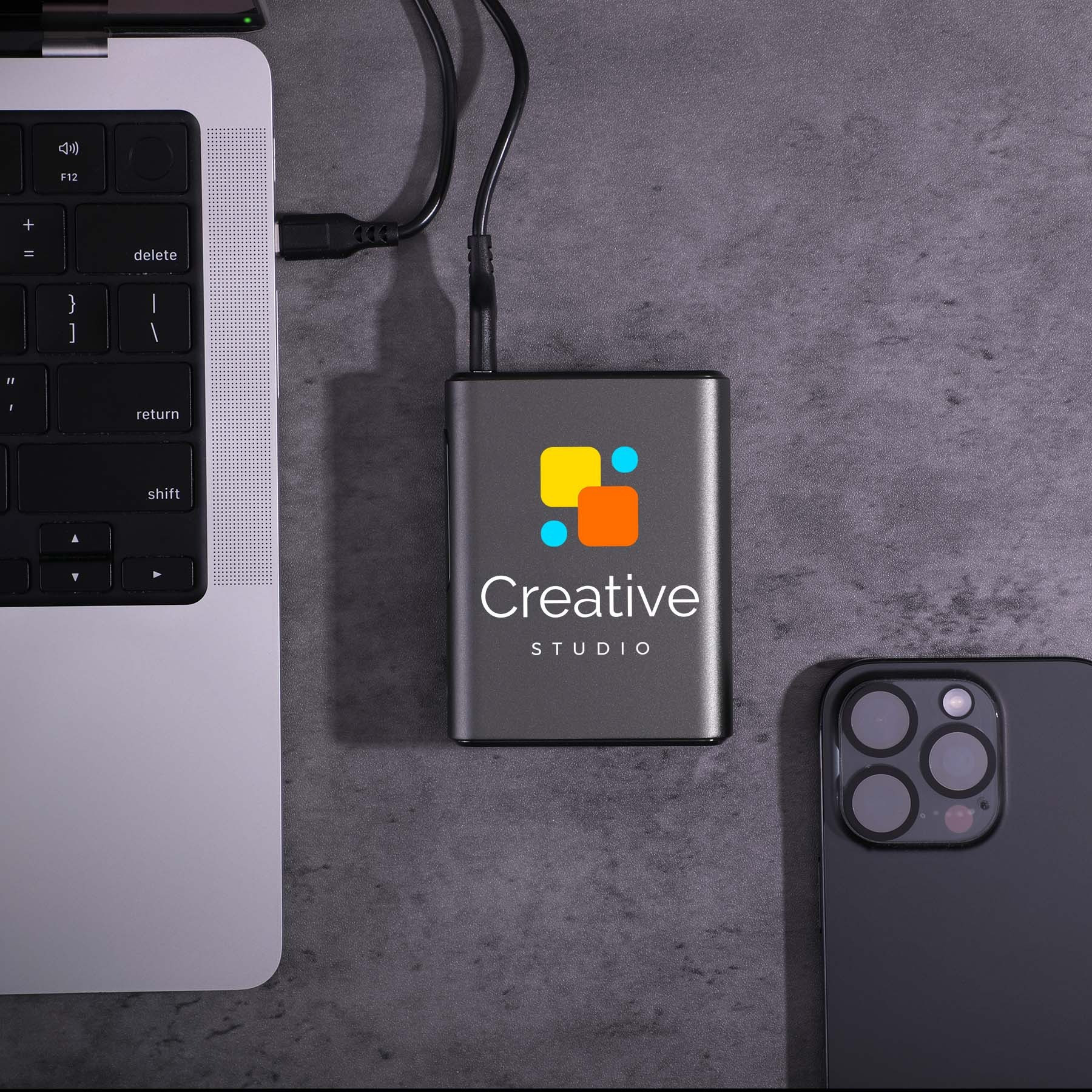Black Big Daddy Laptop Power Bank in a compact black recycled-material shell, featuring a 10,000mAh battery and 45W charging output for laptops, smartphones, tablets, and other compatible devices.
