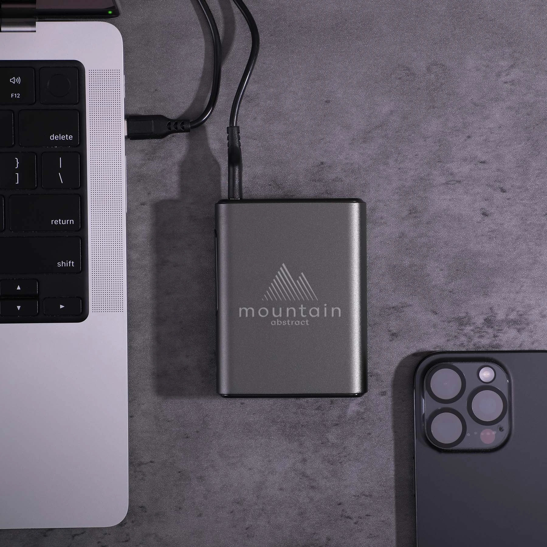 Black Big Daddy Laptop Power Bank in a compact black recycled-material shell, featuring a 10,000mAh battery and 45W charging output for laptops, smartphones, tablets, and other compatible devices.