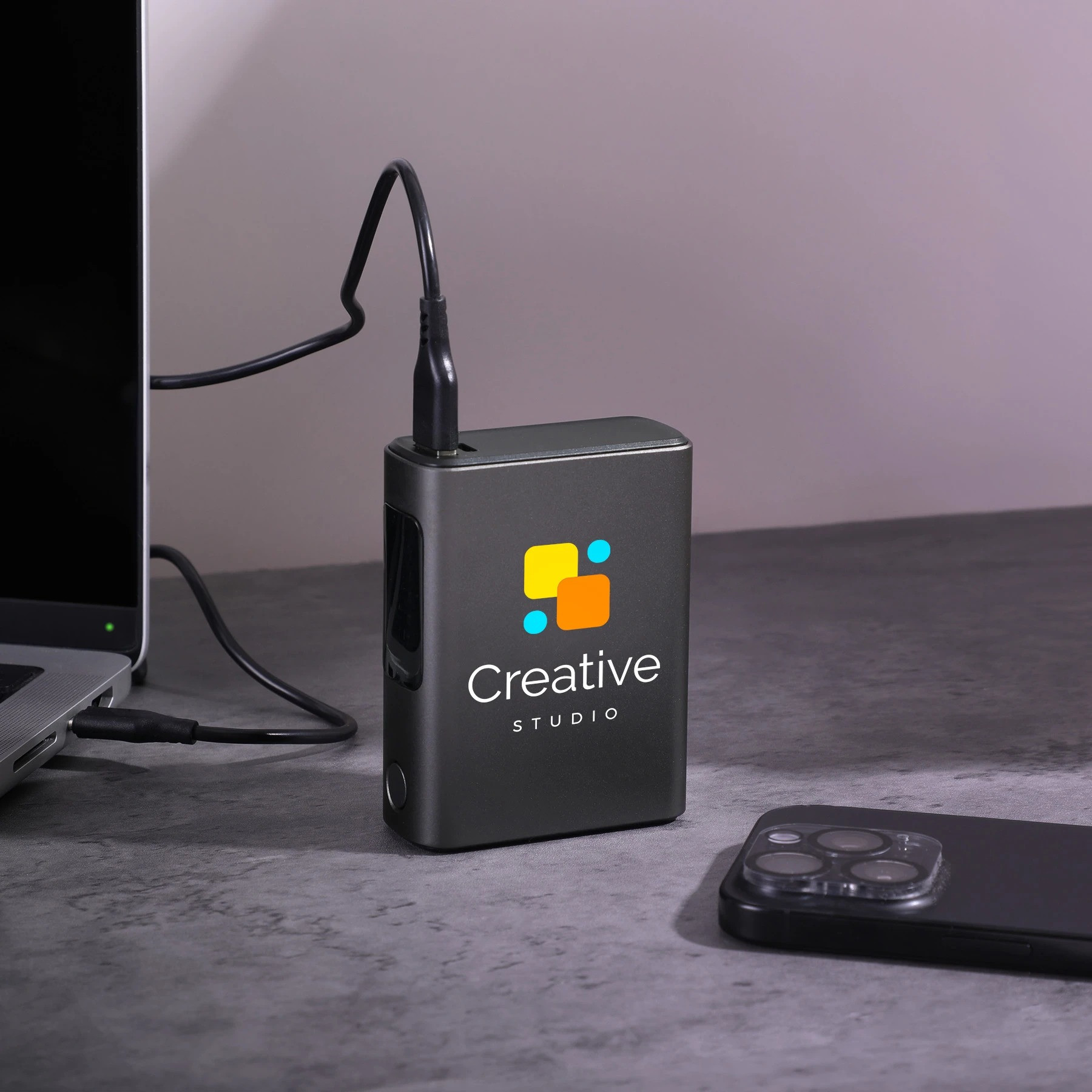 Black Big Daddy Laptop Power Bank in a compact black recycled-material shell, featuring a 10,000mAh battery and 45W charging output for laptops, smartphones, tablets, and other compatible devices.