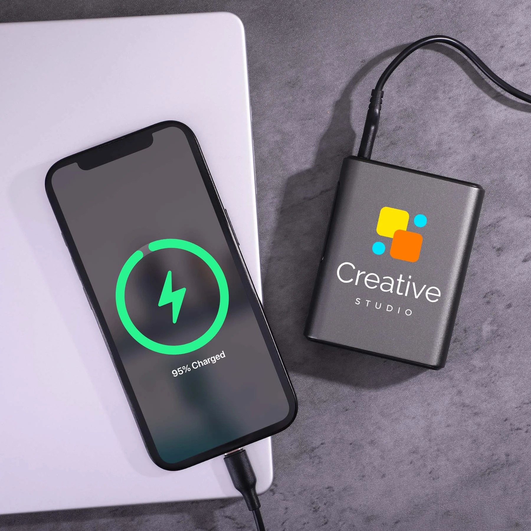 Black Big Daddy Laptop Power Bank in a compact black recycled-material shell, featuring a 10,000mAh battery and 45W charging output for laptops, smartphones, tablets, and other compatible devices.