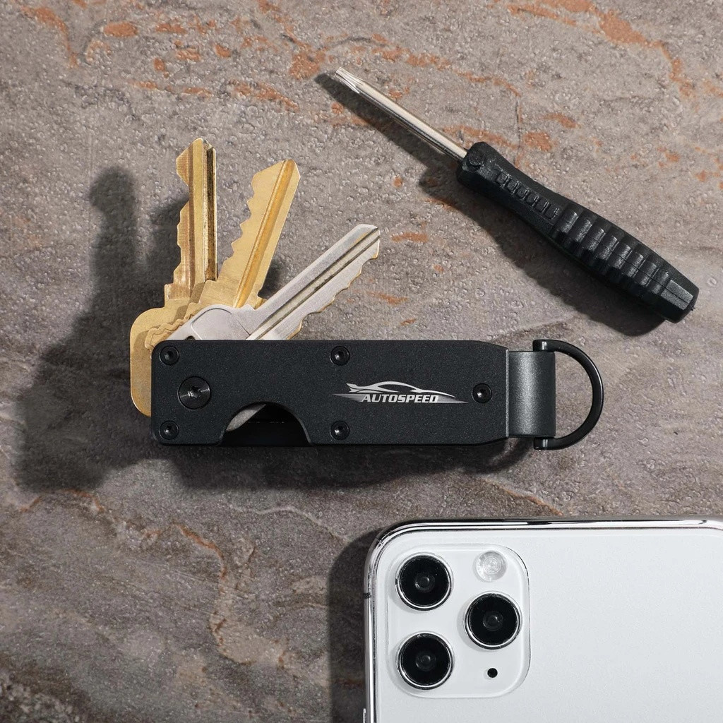 Black aluminum key organizer designed to hold 2-6 keys in a compact configuration, featuring a sleek minimalist design for reducing key bulk and noise.
