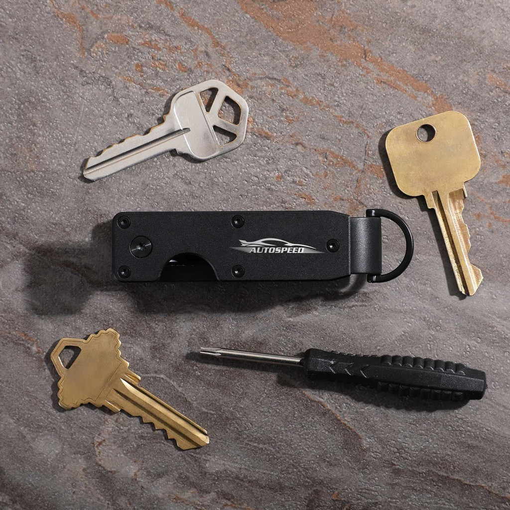 Black aluminum key organizer designed to hold 2-6 keys in a compact configuration, featuring a sleek minimalist design for reducing key bulk and noise.