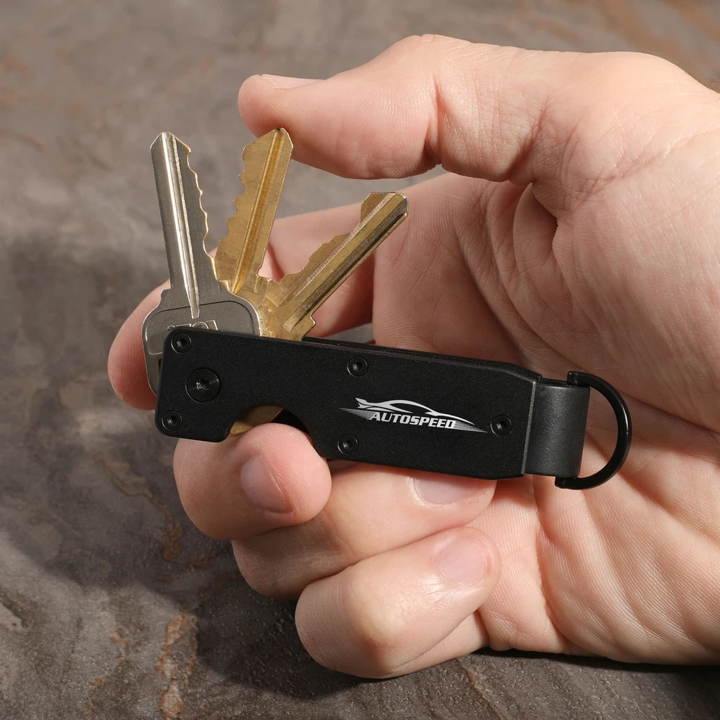 Black aluminum key organizer designed to hold 2-6 keys in a compact configuration, featuring a sleek minimalist design for reducing key bulk and noise.