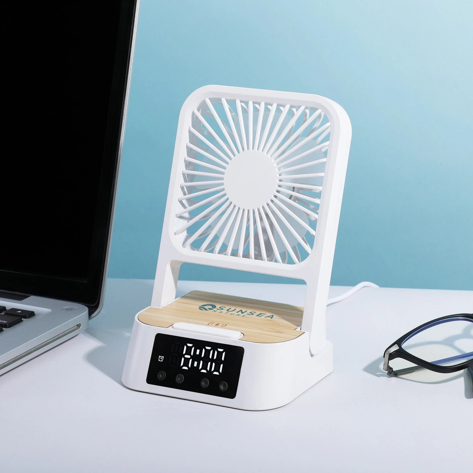 Natural Bamboo/White Cool & Connect 4-in-1 Desk Fan in a compact desktop design with three fan speeds, built-in wireless charging pad, digital clock and alarm display, and phone stand for cooling, charging, and hands-free viewing.