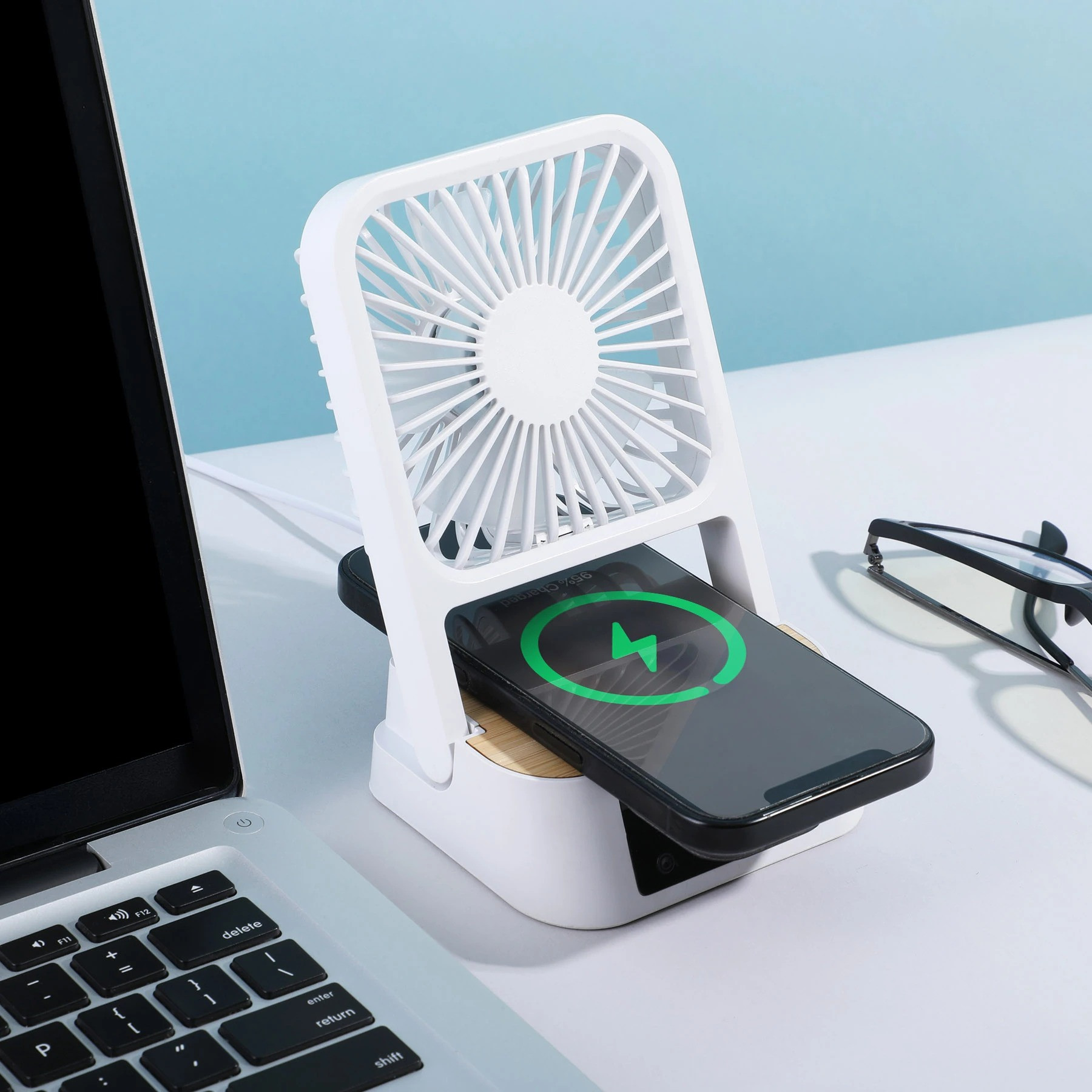 Natural Bamboo/White Cool & Connect 4-in-1 Desk Fan in a compact desktop design with three fan speeds, built-in wireless charging pad, digital clock and alarm display, and phone stand for cooling, charging, and hands-free viewing.