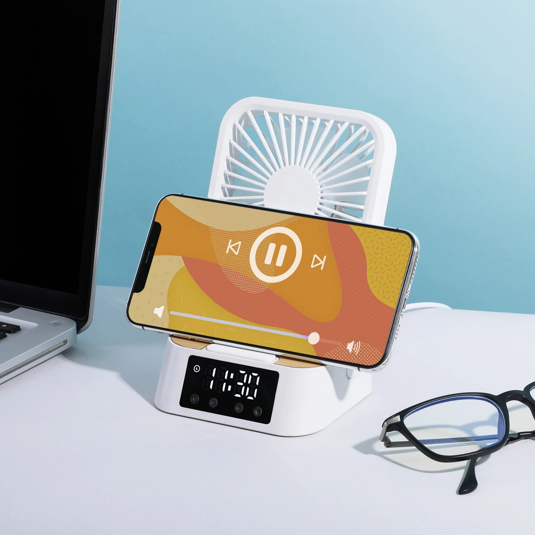 Natural Bamboo/White Cool & Connect 4-in-1 Desk Fan in a compact desktop design with three fan speeds, built-in wireless charging pad, digital clock and alarm display, and phone stand for cooling, charging, and hands-free viewing.