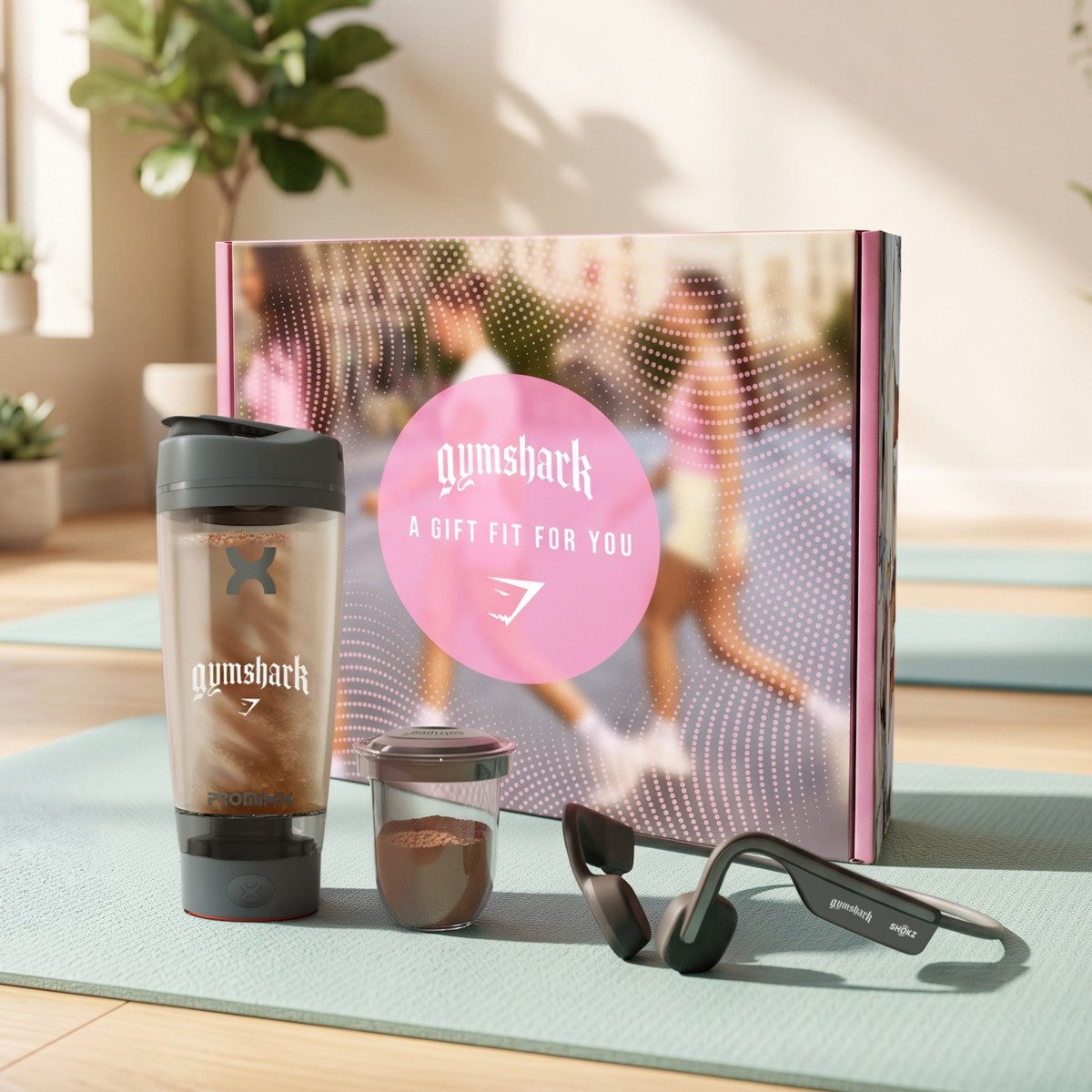 The Ultimate Workout Set featuring black Shokz OpenMove Bluetooth bone-conduction headphones and a 20-ounce Promixx Pro electric shaker bottle, designed for hands-free audio and convenient hydration during workouts.