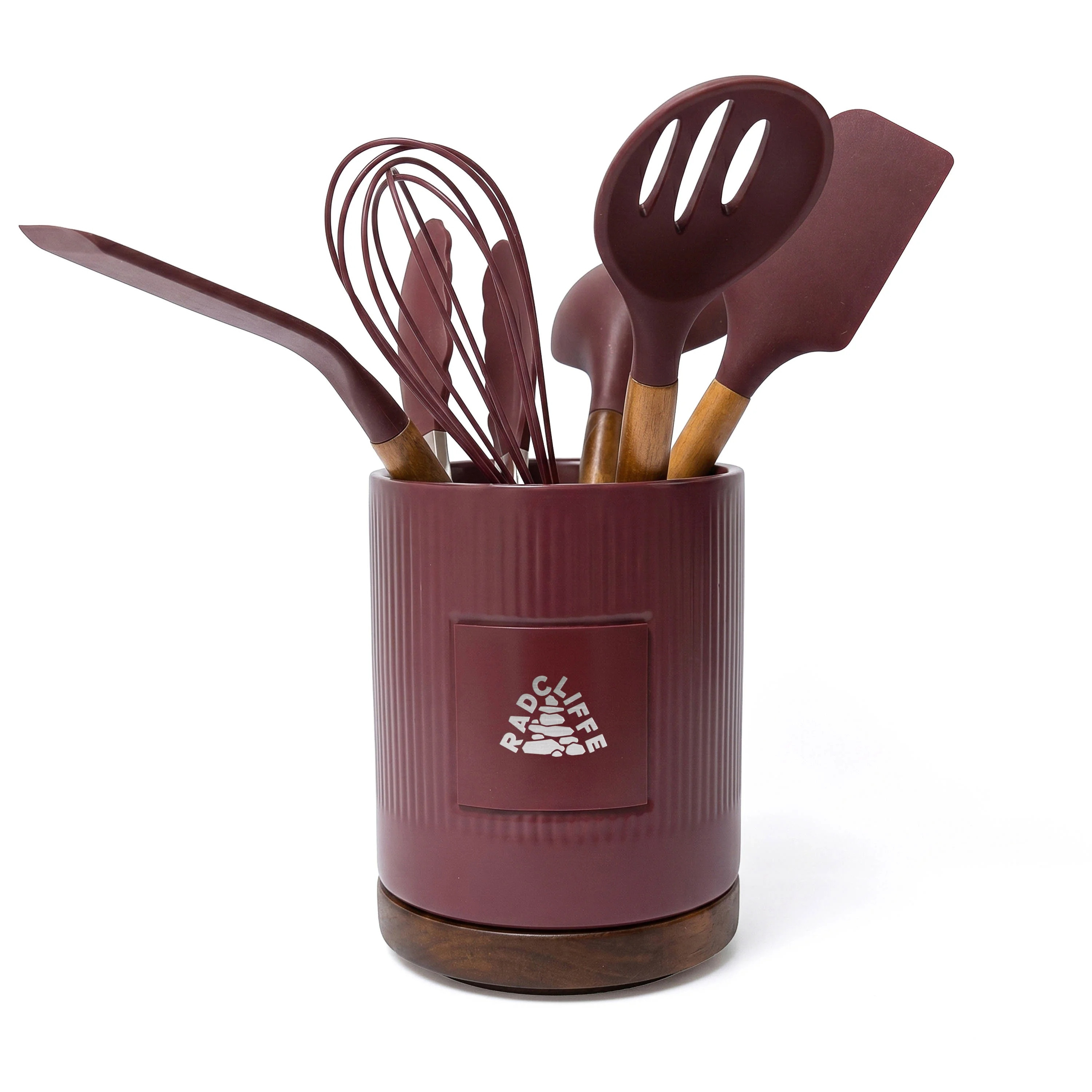 Burgundy stoneware utensil holder and spatula set with silicone spatulas, acacia wood handles, acacia wood base, and metal plate for branding.