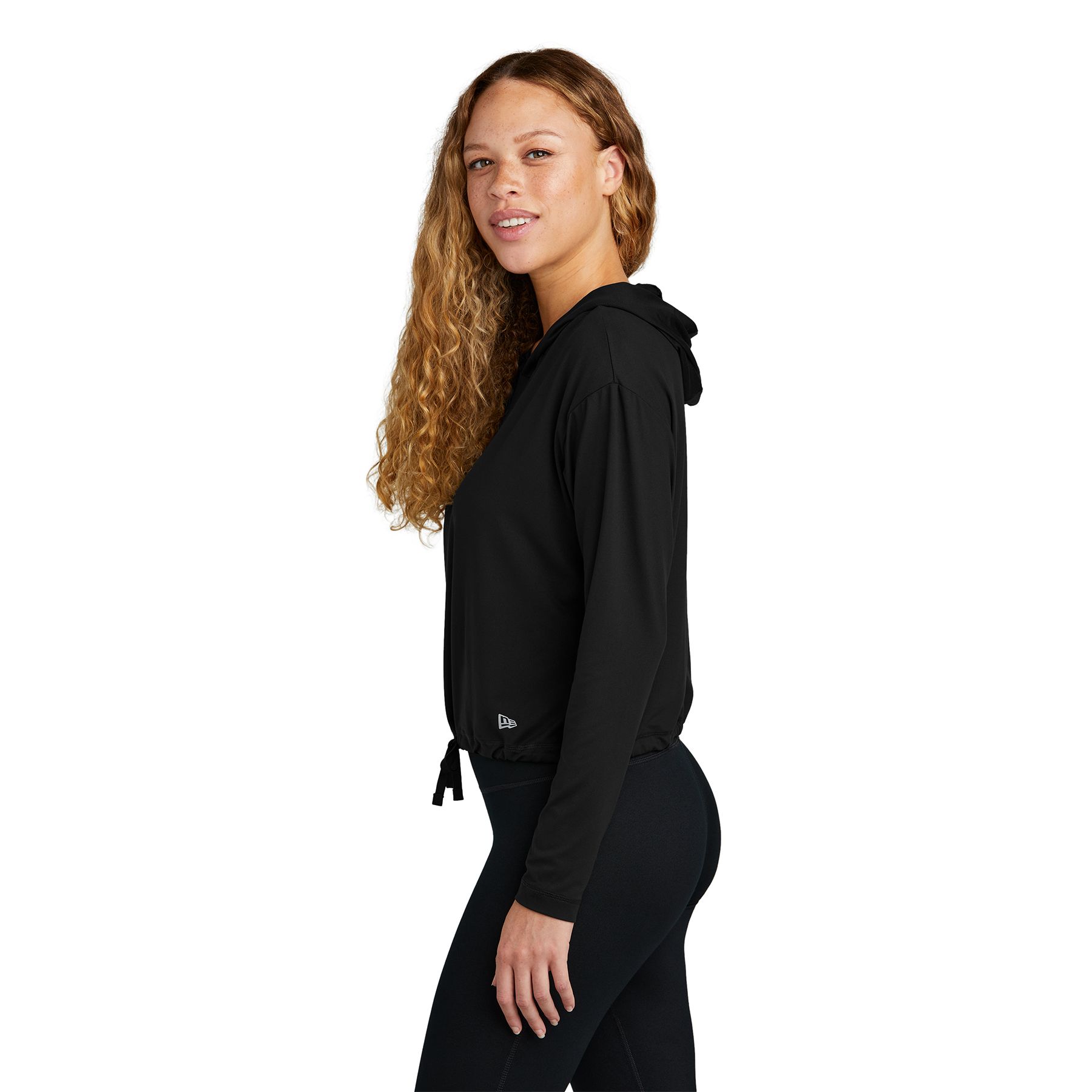 Back New Era Women's Power Long Sleeve Hoodie, featuring a lightweight polyester-spandex stretch fabric, 3-panel hood, long sleeves with thumbholes, high-hip hem with adjustable cinch drawcords, and a subtle reflective silver logo at the left hem, designed for activewear and everyday comfort.