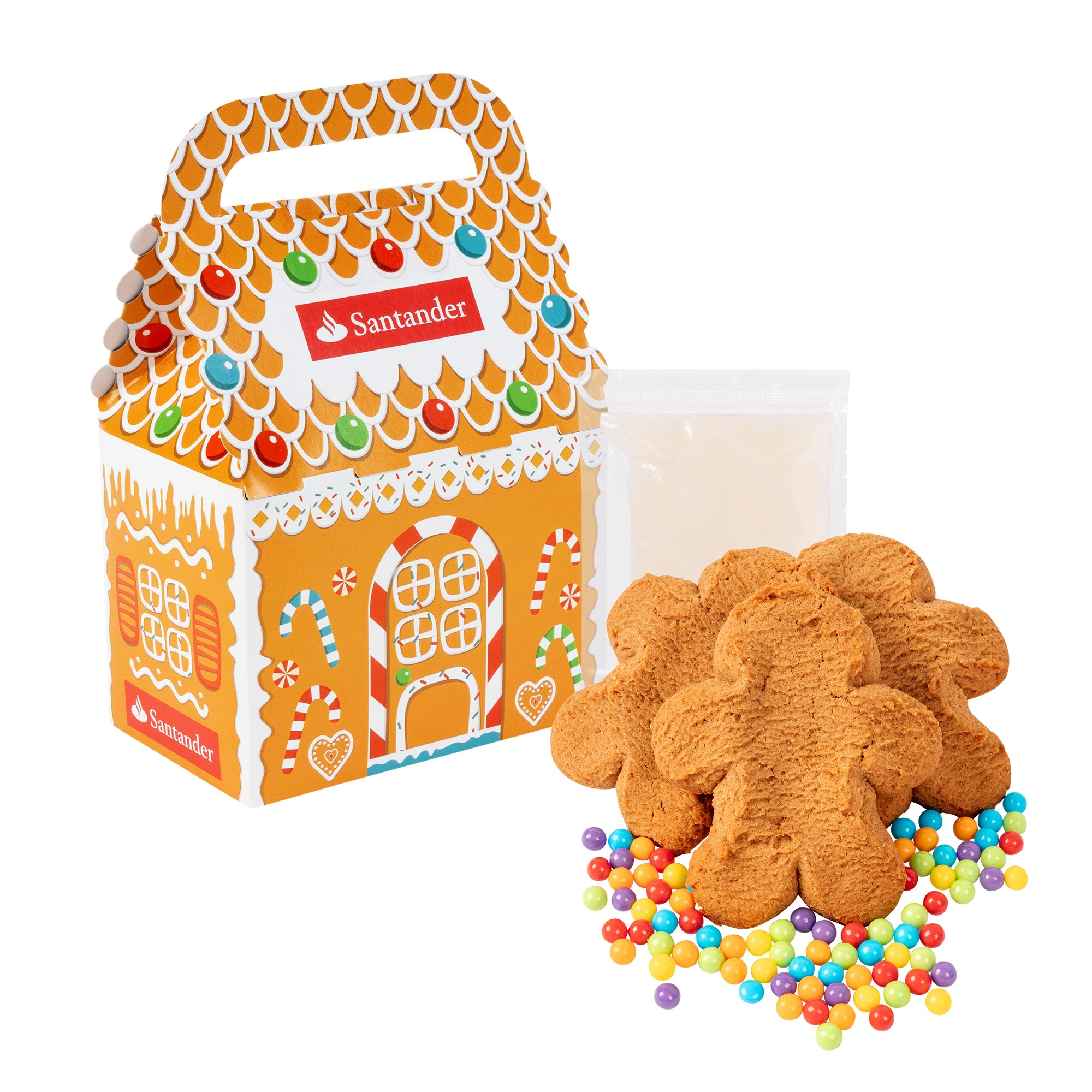 Gingerbread cookie decorating kit in a festive holiday house gift box with three gingerbread cookies, vanilla icing, and colorful candies for a fun seasonal activity.