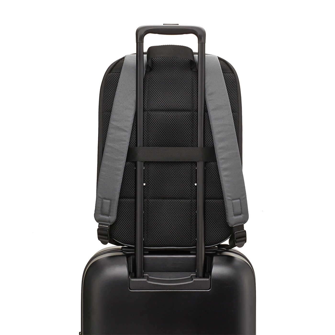 Slate Gray Moleskine® Notebook Backpack in a slim, sleek design, featuring a black water-resistant exterior, padded adjustable shoulder straps, breathable mesh back, and multiple zippered and interior pockets for organizing a laptop, tablet, notebooks, pens, and travel essentials.