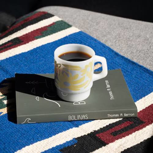 vintage-inspired glass mug with a curved handle, classic milk glass finish, and 8 oz capacity for coffee, tea, and other hot or cold beverages.