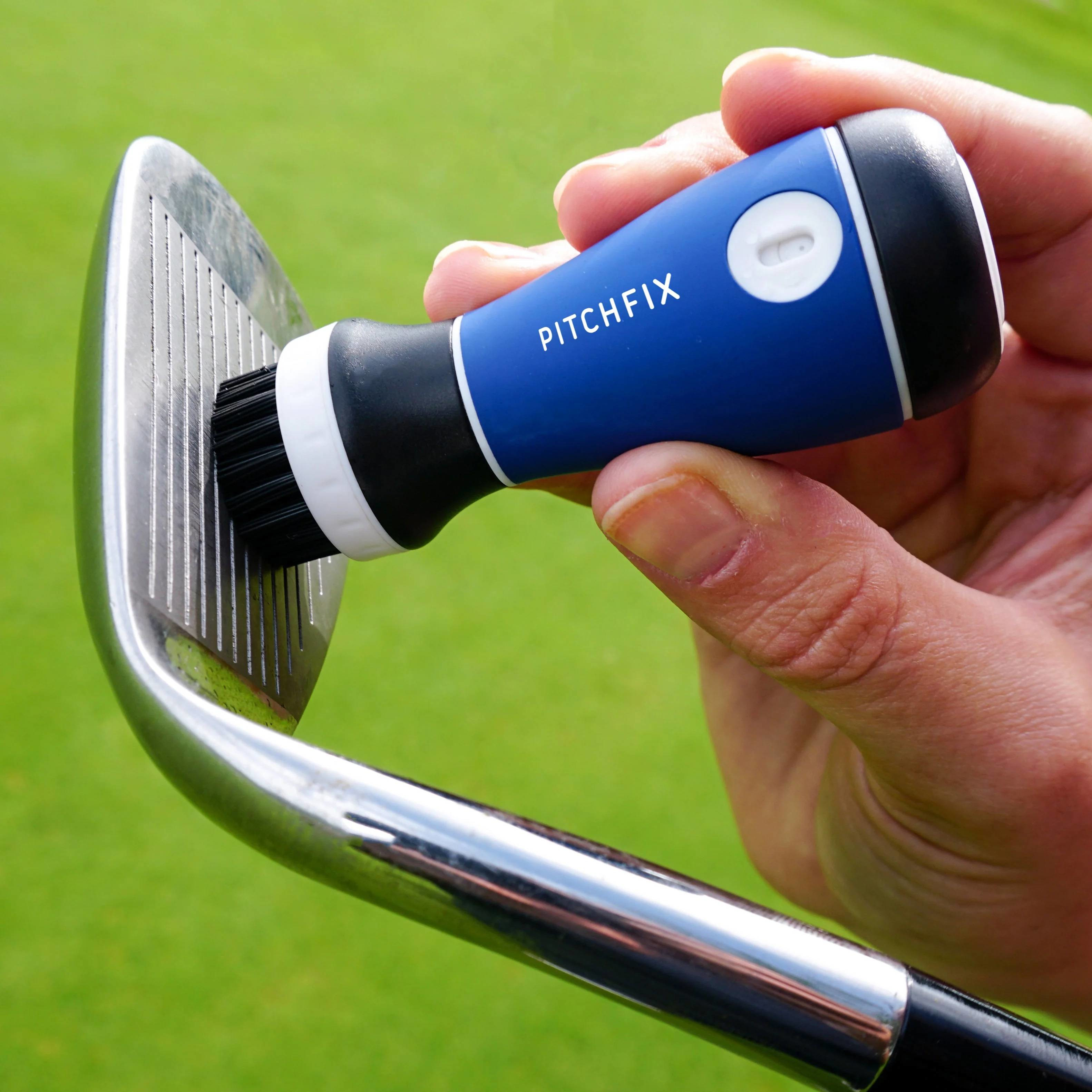 Blue PitchFix golf club cleaner with integrated water spray, replaceable brush head, convenient golf bag attachment, and a brandable cap with a full-color resin dome.