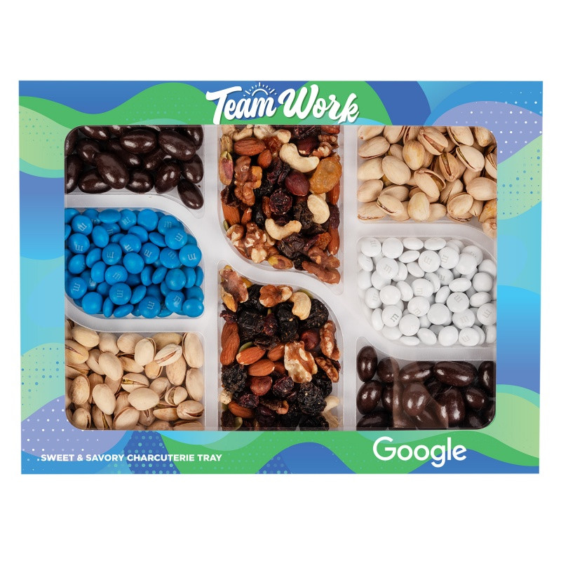 Custom Premium snack gift box featuring an assortment of Champions Mix, colorful M&M’S® candies, dark chocolate-covered almonds, and roasted salted pistachios. Packaged in a full-color, die-cut custom box with vibrant printed graphics, this sweet and savory snack collection is ideal for executive gifts, holiday appreciation, and client thank-you presents.