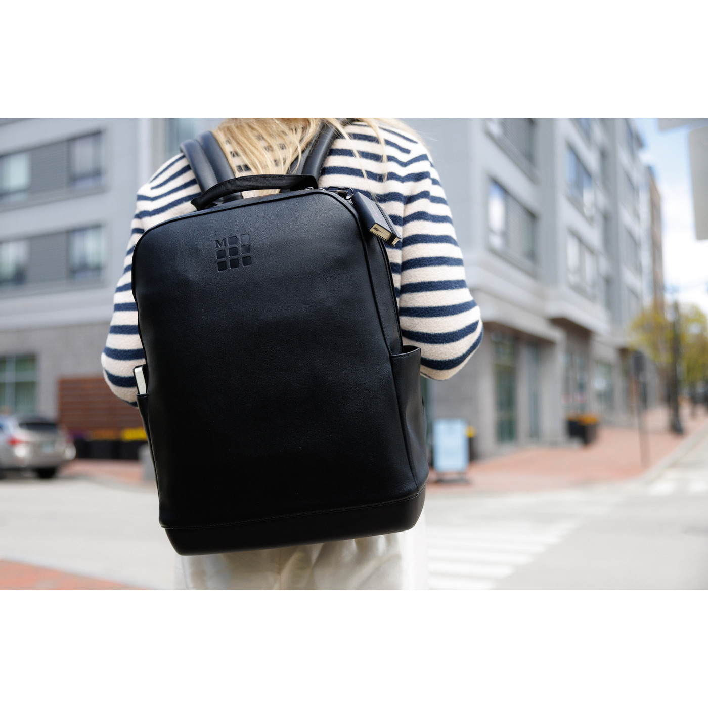 black backpack paired with a mini notebook charm in a two-piece gift set, featuring a sleek professional design.