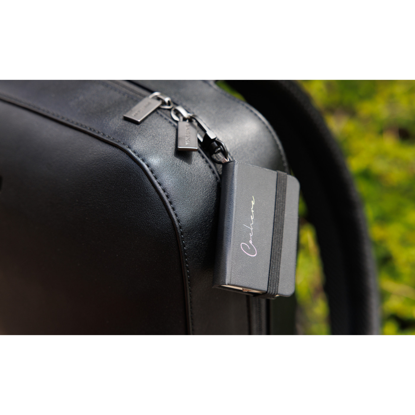 black backpack paired with a mini notebook charm in a two-piece gift set, featuring a sleek professional design.