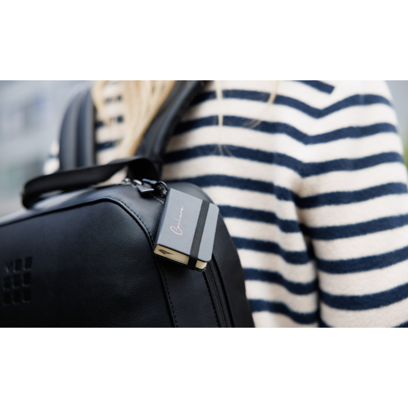 black backpack paired with a mini notebook charm in a two-piece gift set, featuring a sleek professional design.