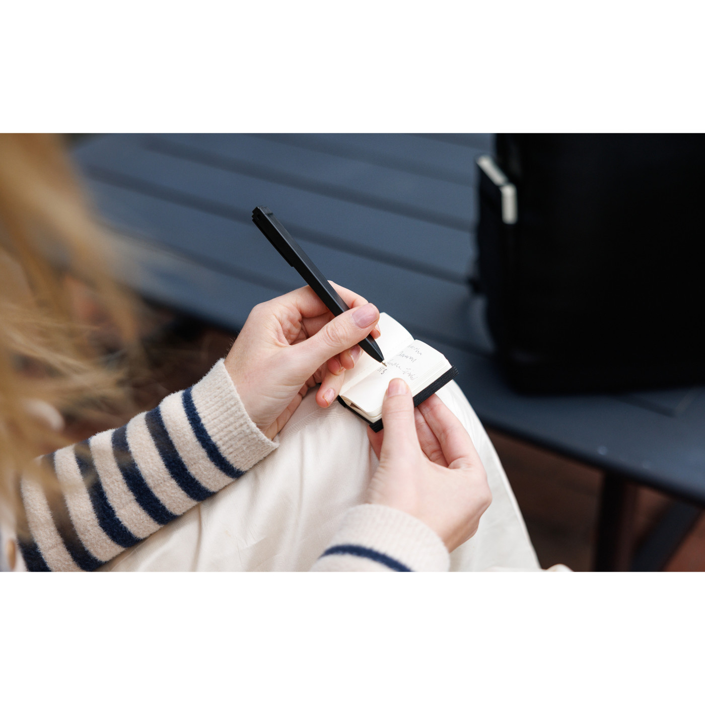 black backpack paired with a mini notebook charm in a two-piece gift set, featuring a sleek professional design.