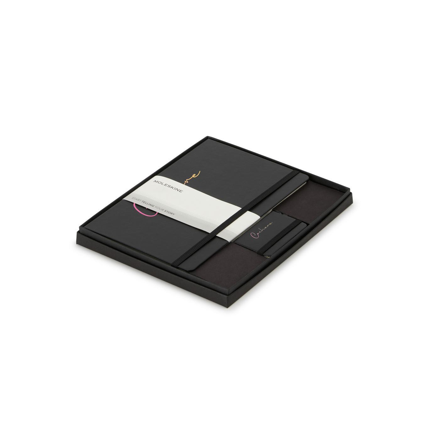 Black Moleskine large hardcover ruled notebook and mini notebook charm gift set, featuring a coordinated writing set presented in an elegant two-piece gift box. The FSC-certified large notebook offers a durable cover and lined pages for note-taking, journaling, and daily organization, while the miniature notebook charm adds a compact decorative touch. Ideal for professional use, corporate gifts, and special events.