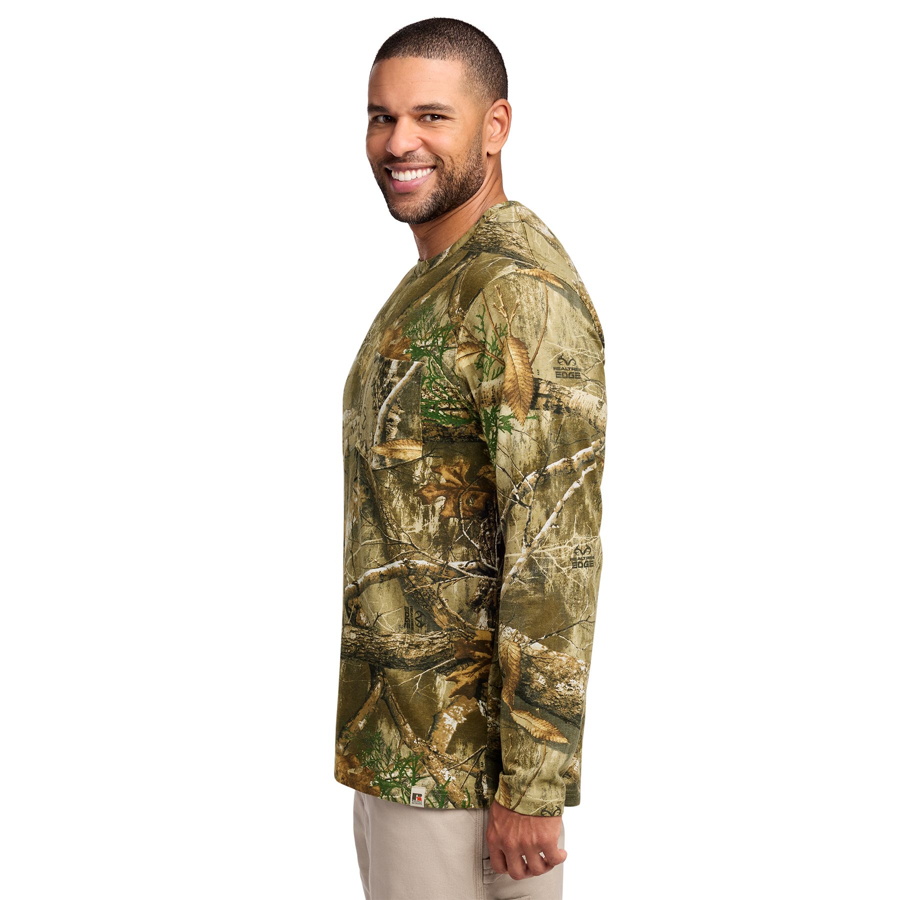 Realtree Edge Long-sleeve Realtree EDGE® camouflage pocket T-shirt made from 5.5-ounce, 100% ring-spun combed cotton for a soft, comfortable feel. Features an outdoor-inspired camouflage pattern, a left chest pocket, a ribbed collar with reinforced stitching, shoulder-to-shoulder neck taping, and an exterior woven hem tab. Designed for outdoor work, casual wear, and custom-branded promotional apparel.