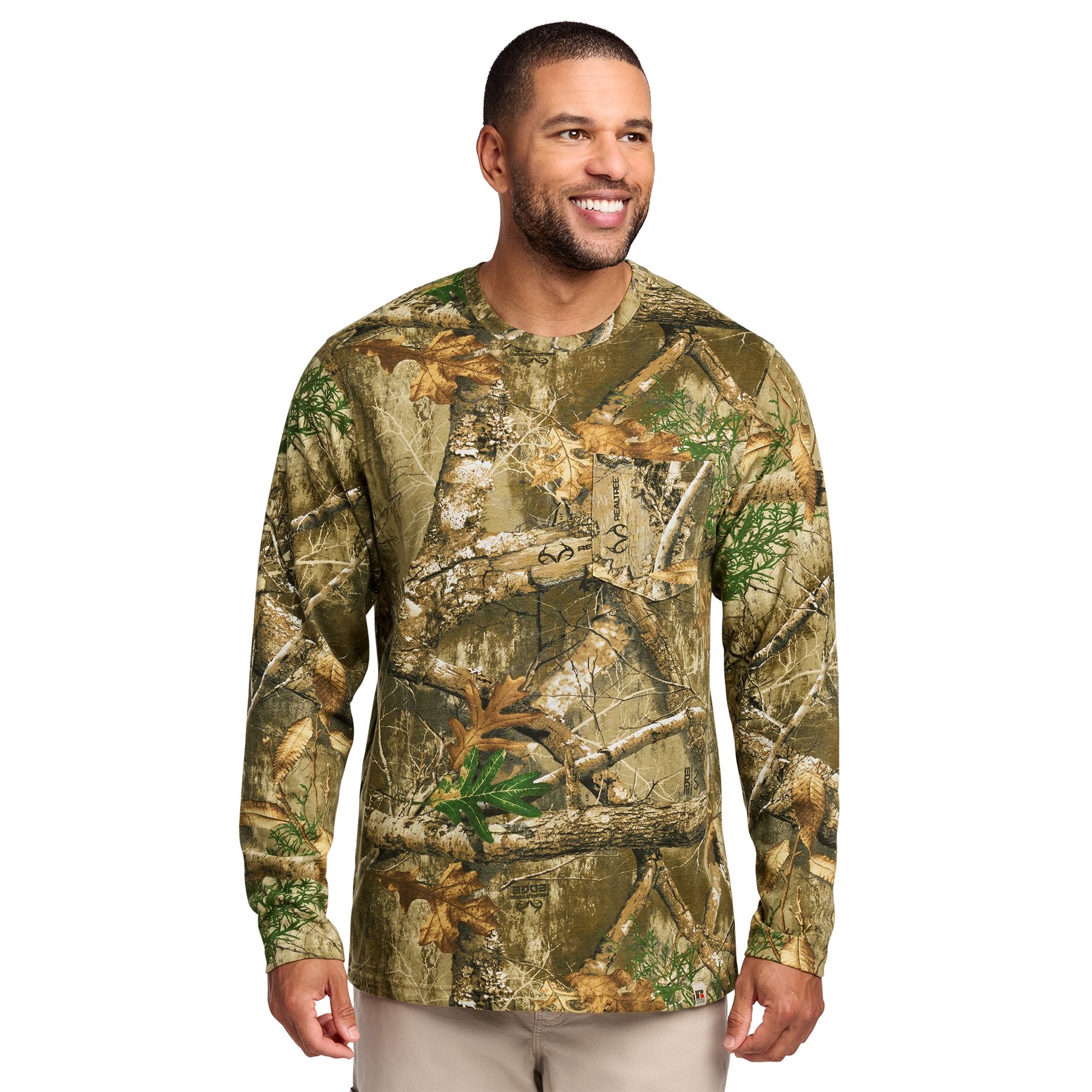 Realtree Edge Long-sleeve Realtree EDGE® camouflage pocket T-shirt made from 5.5-ounce, 100% ring-spun combed cotton for a soft, comfortable feel. Features an outdoor-inspired camouflage pattern, a left chest pocket, a ribbed collar with reinforced stitching, shoulder-to-shoulder neck taping, and an exterior woven hem tab. Designed for outdoor work, casual wear, and custom-branded promotional apparel.